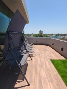 a group of chairs sitting on the roof of a building at San Pedro, Cristal INN in San Pedro