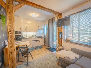 a kitchen and living room with a couch and a table at Lazy Deer - Camp in Staniszów