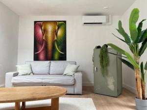 a living room with a couch and a painting of an elephant at The Vault - Eindhoven - By T&S in Eindhoven