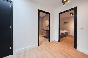 a room with a bedroom with a bed and a mirror at The Vault - Eindhoven - By T&S in Eindhoven