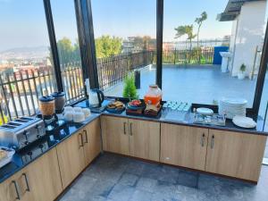 a kitchen with a counter with a view of a balcony at Kynjing Suites in Shillong