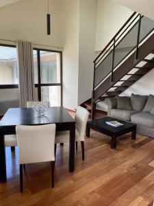 a living room with a dining room table and a couch at Appartement 3 étoiles - eecfga in Saint-Lizier