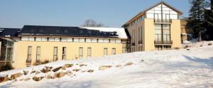a building on a snow covered hill in front of a building at Appartement 3 étoiles - eecfga in Saint-Lizier +20 photos