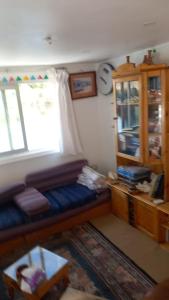 a living room with a couch and a window at Nile Dream Yacht in Jazīrat Salūjah