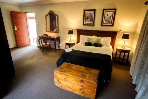 a bedroom with a bed and a table in a room at The Black Swann in Queenstown