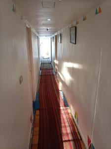 a long hallway with a red carpet on the floor at Nile Dream Yacht in Jazīrat Salūjah