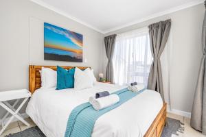 a bedroom with a large bed and a window at Coral Grove in Strand +18 photos