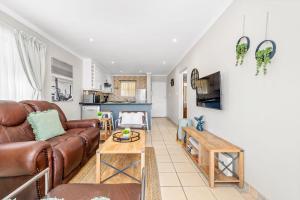 a living room with a couch and a table at Coral Grove in Strand