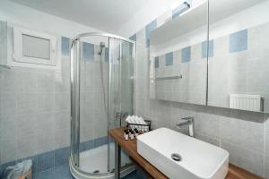 a bathroom with a sink and a shower at Livingstone House in Porto Rafti