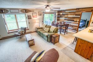 a living room with a couch and a table at On River Time Bring Your Pup Pool in Bartlett