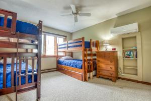 a bedroom with two bunk beds and a ceiling fan at On River Time Bring Your Pup Pool in Bartlett +21 photos