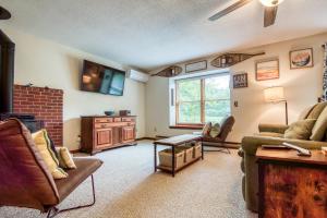 a living room with a couch and a tv at On River Time Bring Your Pup Pool in Bartlett