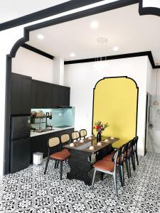 a dining room with a table and chairs at Villa RonRoy Hà Tiên in Hà Tiên