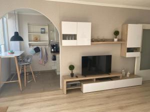 a living room with a flat screen tv on a table at Ferienwohnung Deichblick in Bremerhaven +2 photos