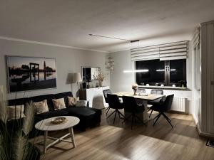 a living room with a couch and a table at Ferienwohnung Deichblick in Bremerhaven