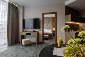 a hotel room with a bed and a television at Silver Apart in Truskavets
