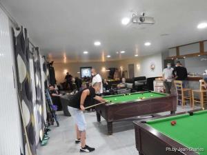 a man playing a game of pool in a room at ZEcamping 4 étoiles piscine couverte piscine chauffée locatif 4 pers in Wavans
