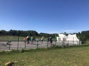 a group of people standing near a fence with a tent at ZEcamping 4 étoiles piscine couverte piscine chauffée locatif 4 pers in Wavans +34 photos