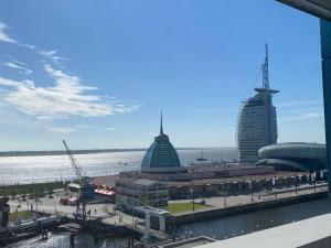 a view of a city with buildings and the water at Ferienwohnung Deichblick in Bremerhaven
