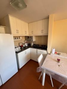 a small kitchen with a table and a refrigerator at Plaza murillo in La Paz