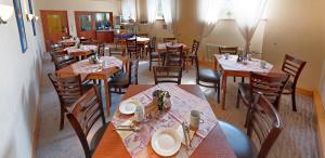 a dining room with tables and chairs in a restaurant at Hotel Keinath Stuttgart in Stuttgart +5 photos
