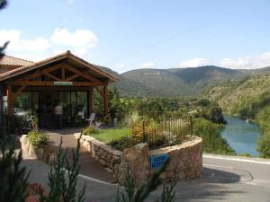 a pavilion with a view of a river and mountains at ZEcamping 4 étoiles familial animaux acceptés animé équitation in Saint-Rome-de-Tarn