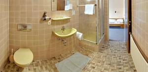 a bathroom with a toilet and a sink and a shower at Hotel Keinath Stuttgart in Stuttgart
