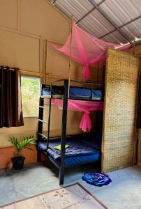 a room with bunk beds with a pink canopy at Sea PoeTree in Koh Rong Sanloem +27 photos