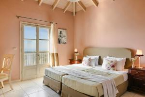 a bedroom with a large bed and a window at Nikolas by Vintage Travel in Fiskardo +34 photos