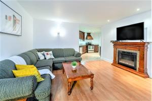 a living room with a couch and a fireplace at Magnifique condo 2 chambres in Beaupré