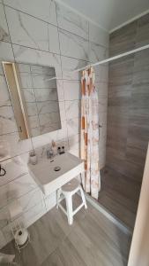 a white bathroom with a sink and a mirror at Antzela Apartments in Sidari +219 photos