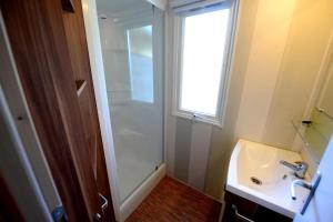 a bathroom with a glass shower and a sink at ZEcamping 4 étoiles familial animaux acceptés animé équitation in Saint-Rome-de-Tarn