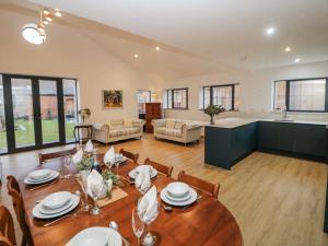a dining room and living room with a table at Courtyard View in Ashbourne