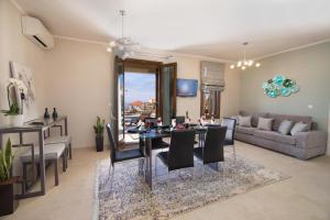 a dining room and living room with a table and chairs at Vasilikades by Vintage Travel in Fiskardo