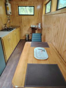 a room with a wooden table in a kitchen at Cabañas Del Monte 2 in Melipeuco