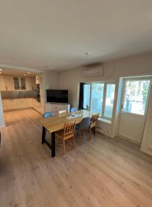 a kitchen and dining room with a table and chairs at Nobelgården in Harstad +7 photos