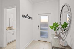 a white room with a mirror and a table at Special 4bedroom TH w-private pool next to Disney in Kissimmee