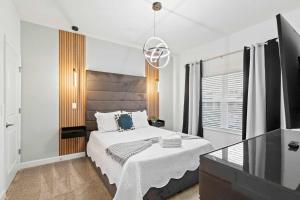 a bedroom with a large bed and a television at Special 4bedroom TH w-private pool next to Disney in Kissimmee