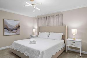 a bedroom with a white bed with two night stands at Special 4bedroom TH w-private pool next to Disney in Kissimmee