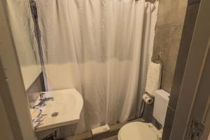 a bathroom with a sink and a toilet and a shower at HOTEL CONCEPT BARILOCHE in San Carlos de Bariloche +22 photos