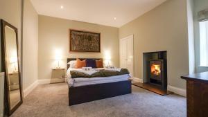 a bedroom with a bed and a fire place at Summers Nook in Humshaugh