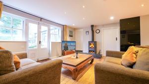 a living room with two couches and a coffee table at Summers Nook in Humshaugh
