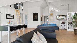 a living room with a pool table and a couch at Villavilla 596 - Rømø, Sydjylland in Høm