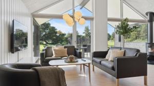 a living room with couches and a table at Villavilla 596 - Rømø, Sydjylland in Høm +19 photos