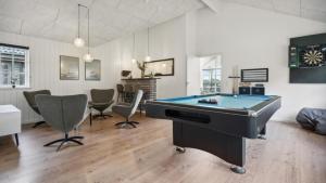 a living room with a pool table and chairs at Villavilla 520 - Mommark, Sydjylland in Sarup +24 photos
