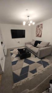 a living room with a couch and a flat screen tv at 3,Lime Tree Ave in Haverfordwest