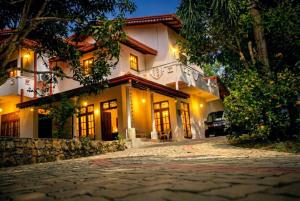 a house with a cobblestone street in front of it at The Nature in Tangalle