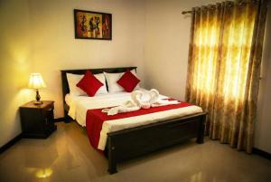 a bedroom with a bed with towel animals on it at The Nature in Tangalle +3 photos