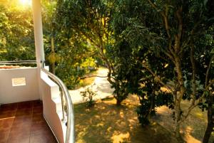 a balcony with a view of a tree at The Nature in Tangalle