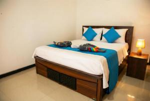 a bedroom with a bed with two bags on it at The Nature in Tangalle
